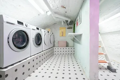 a laundry room with three washing machines in it at SHWAY - The Pink Pigeon in Antwerp