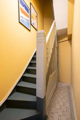 a hallway with stairs in a house at SHWAY - The Pink Pigeon in Antwerp