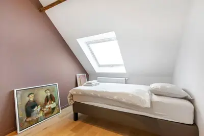 a bedroom with a bed with a skylight at Design Loft near the city of Ghent in Ghent