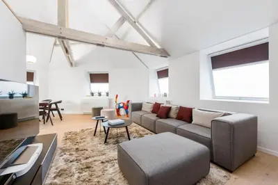 a living room with a couch and a table at Design Loft near the city of Ghent in Ghent