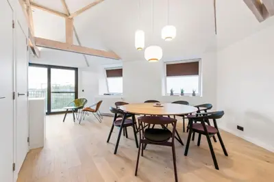 a kitchen and dining room with a table and chairs at Design Loft near the city of Ghent in Ghent