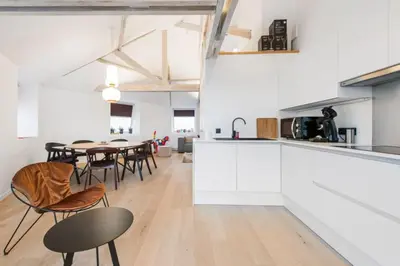 a kitchen and dining room with a table and chairs at Design Loft near the city of Ghent in Ghent