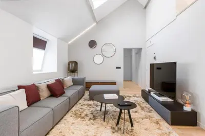 a living room with a couch and a tv at Design Loft near the city of Ghent in Ghent