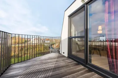 a balcony with sliding glass doors and a view at Design Loft near the city of Ghent in Ghent