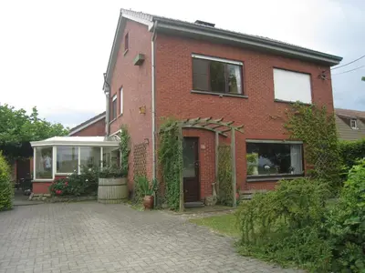 a brick house with a driveway in front of it at Vakantiehuis in de velden met zwemvijver en Jeu de Boules baan in Lier