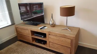 a flat screen tv sitting on top of a wooden entertainment center at Huis van Vletingen Apartment in Ghent