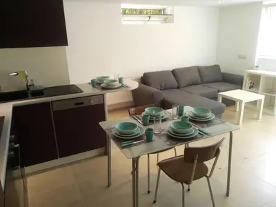 a living room with a table with plates on it at Comfortable Apartment in Waterloo with Jacuzzi - 78m² in Waterloo