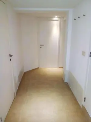 an empty hallway with a white door and a wooden floor at Comfortable Apartment in Waterloo with Jacuzzi - 78m² in Waterloo