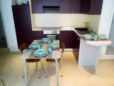 a kitchen with a table with chairs and plates on it at Comfortable Apartment in Waterloo with Jacuzzi - 78m² in Waterloo