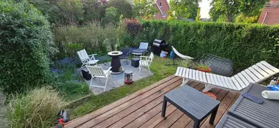 a wooden deck with chairs and a table and a grill at Comfortable Apartment in Waterloo with Jacuzzi - 78m² in Waterloo