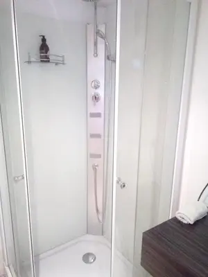 a shower with a glass door in a bathroom at Comfortable Apartment in Waterloo with Jacuzzi - 78m² in Waterloo