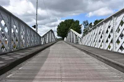 a bridge with a wooden walkway at Vakantiewoning Lescaut in Hamme