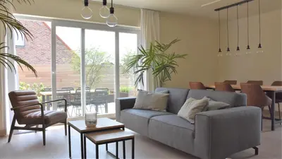 a living room with a couch and a table at Vakantiewoning Lescaut in Hamme