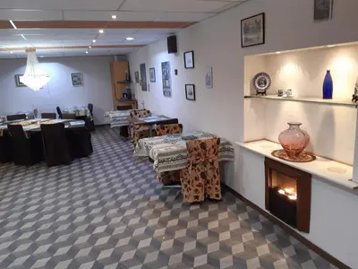 a room with tables and a fireplace in a store at Casa di Cynthia in Antwerp