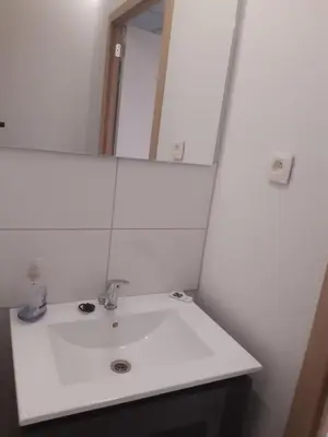 a bathroom with a white sink and a mirror at Casa di Cynthia in Antwerp