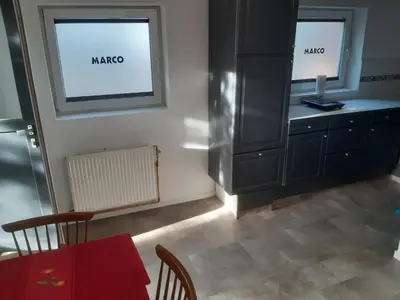 a dining room with a red table and a cabinet at Casa di Cynthia in Antwerp