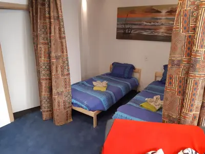 a room with two twin beds and curtains at Casa di Cynthia in Antwerp