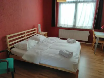 a bedroom with a bed with two towels on it at Brussels BnB in Brussels