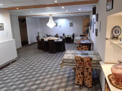 a dining room with tables and chairs in a room at casa di Claudia in Antwerp