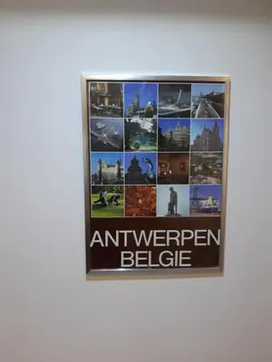 a framed picture on a wall with a sign that reads antwerpen belge at casa di Claudia in Antwerp
