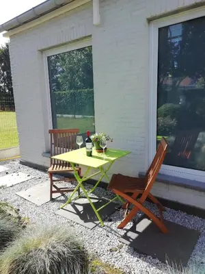 a picnic table and two chairs on a patio at The Mill 2380 in Ravels