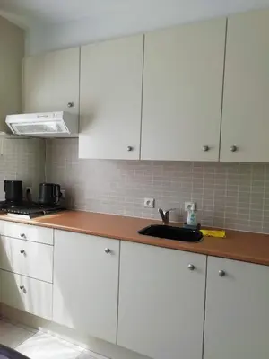 a kitchen with white cabinets and a sink at The Mill 2380 in Ravels