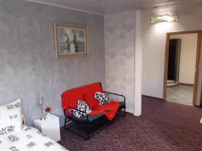 a bedroom with a red chair and a bed at casa di Gino in Antwerp