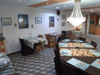 a dining room with tables and chairs and a chandelier at casa di Gino in Antwerp
