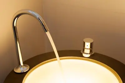 a bathroom sink with a faucet on a counter at B&B Snooz Inn in Ghent