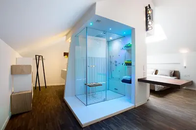a glass shower in a bathroom with a sink at B&B Snooz Inn in Ghent