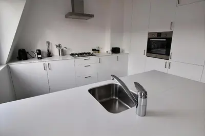 a kitchen with a sink and a white counter top at Rent a flat - Montgomery in Brussels