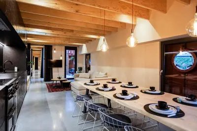 a kitchen and living room with a table with dishes on it at Juno Boat in Ghent
