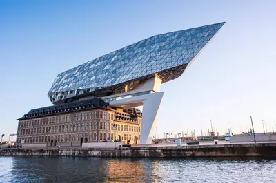a building with a glass roof next to a body of water at Theaterstudio 2 Antwerp in Antwerp