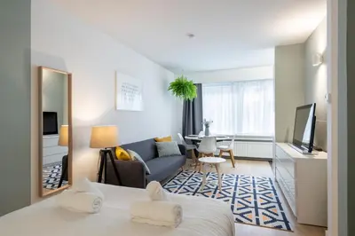 a hotel room with a bed and a living room at Theaterstudio 2 Antwerp in Antwerp