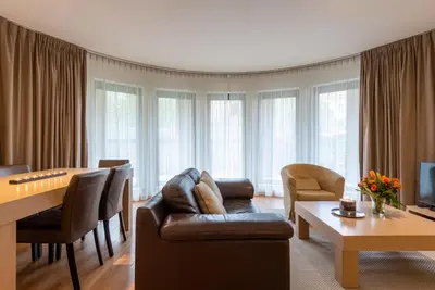 a living room with a couch and a table at EU Parliament Terrace Residence in Brussels