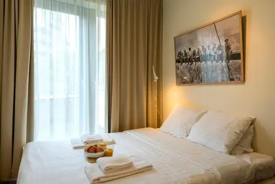 a hotel room with a bed with towels on it at EU Parliament Terrace Residence in Brussels