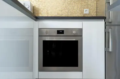 a kitchen with a stove top oven in a kitchen at COZY APARTMENT IN BRUSSELS in Brussels