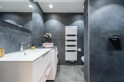 a bathroom with a white sink and a toilet at COZY APARTMENT IN BRUSSELS in Brussels