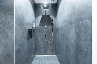 a bathroom with a shower with a glass door at COZY APARTMENT IN BRUSSELS in Brussels