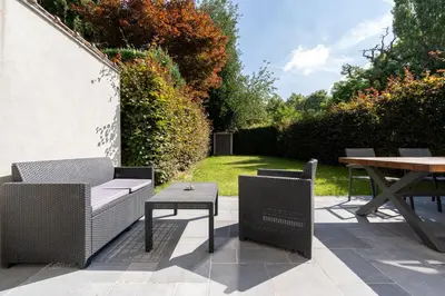 a patio with a table and two chairs and a table at COZY APARTMENT IN BRUSSELS in Brussels