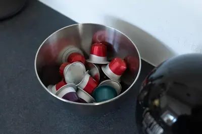 a metal cup filled with different colored spoons at COZY APARTMENT IN BRUSSELS in Brussels