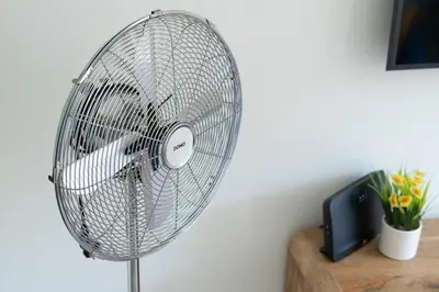 a silver fan sitting on top of a table at COZY APARTMENT IN BRUSSELS in Brussels