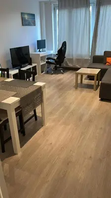 a living room with a couch and tables and a chair at Best nest in Brussels