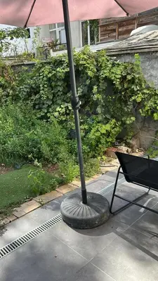 an umbrella sitting on a patio next to a chair at Best nest in Brussels