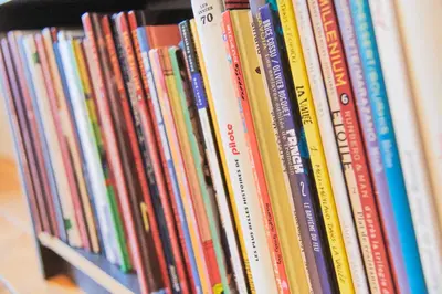 a row of books sitting on a shelf at Studio au plein centre de la ville in Brussels