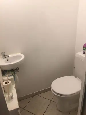 a bathroom with a white toilet and a sink at Studio au plein centre de la ville in Brussels