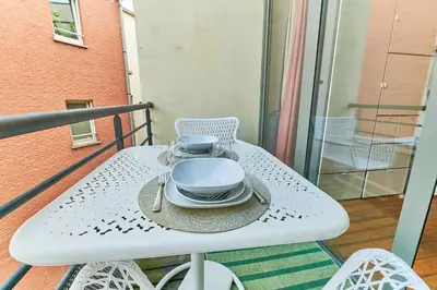 a table with plates and bowls on a balcony at Studio au plein centre de la ville in Brussels