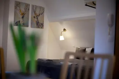 a bedroom with a bed and a lamp on the wall at Luxury Suites Riverside Residence by Rikas Hotels in Antwerp