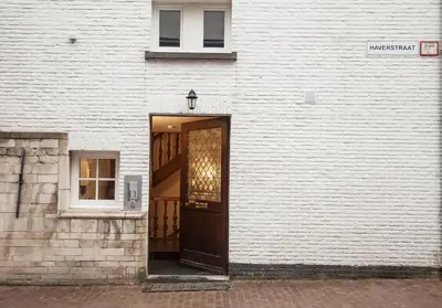 a door to a building with a white wall at Luxury Suites Riverside Residence by Rikas Hotels in Antwerp