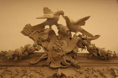 a statue of birds on top of a building at HOFMARKGRAAF - Unique apartment in historic Antwerp mansion in Antwerp